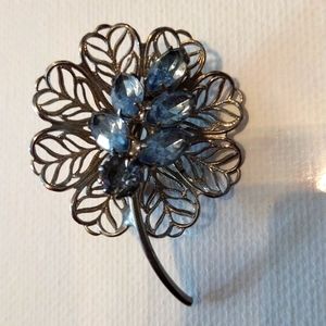 Vintage floral silver brooch with aqua color gem stones.